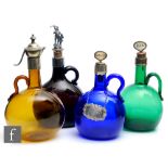 A collection of Victorian finger loop decanters, of varying colours, each of globular form with loop