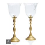 A pair of 20th Century brass candlesticks, circular bases rising to baluster columns and circular