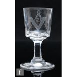 A 19th Century tavern glass with bucket bowl engraved with a Masonic emblem, above a capstan stem