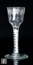 An 18th Century drinking glass, circa 1765, with a fluted ogee bowl engraved with leaves and