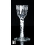 An 18th Century drinking glass, circa 1765, with a fluted ogee bowl engraved with leaves and