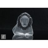 A 20th Century Mats Jonasson clear crystal glass paperweight, modelled as a stylised lion in relief,
