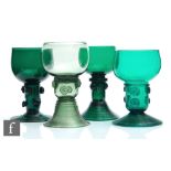 A group of four 19th Century Bristol green drinking glasses to comprise four variant Roemer type