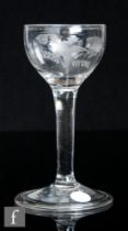 An 18th Century drinking glass, circa 1750, the cup bowl engraved with a bird in flight with a