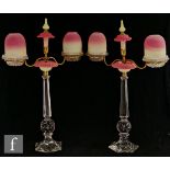 A pair of 19th Century Clarke's Cricklite two arm candelabra, each with a pressed glass candle