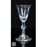 An 18th Century Balustroid drinking glass circa 1750, the round funnel bowl with basal solid section