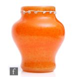 A Monart glass vase, circa 1924, of baluster form, orange stone ware ground over opal with applied