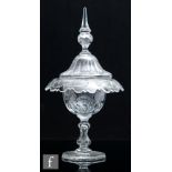 A large 19th Century clear crystal glass pedestal bowl and cover, the radial star cut base rising to
