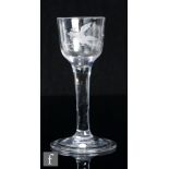 An 18th Century drinking glass, circa 1750, the ogee bowl engraved with a bird in flight with a