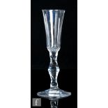 An 18th Century drinking glass, circa 1785, the slender, high sided rounded funnel bowl above a