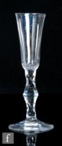An 18th Century drinking glass, circa 1785, the slender, high sided rounded funnel bowl above a