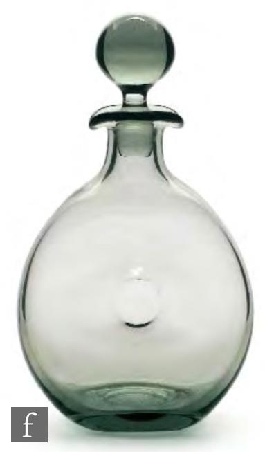 A post war glass decanter designed by Per Lutken for Holmegaard, 1954, of ovoid dimpled form with