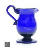 A late Georgian Bristol Blue pedestal cream jug, circa 1800, the baluster form body with integral