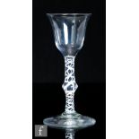 An 18th Century drinking glass, circa 1765, the ogee bowl with everted rim, over a double series