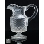 A 19th Century Anglo-Irish style clear crystal glass water jug of pedestal form with cylindrical