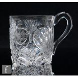 A 19th Century Irish clear cut crystal tankard of cylindrical form with a high arched thumb rest