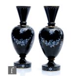 A pair of 19th Century French glass vases, of footed shouldered ovoid form with conical necks,
