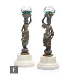 A pair of 19th Century miniature Clichy paperweights, the facet domes internally decorated with