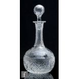 A 1920s Stevens & Williams clear crystal glass decanter of globe and shaft form with hollow blown