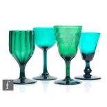 A group of four 19th Century Bristol green drinking glasses to comprise a fluted ogee bowl with