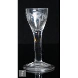 An 18th Century drinking glass, circa 1740, the pointed round funnel bowl engraved with a bird in