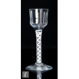 An 18th Century drinking glass circa 1765, the ogee form bowl above an opaque twist stem with two