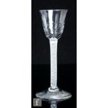 An 18th Century drinking glass, circa 1760, the round planished funnel bowl above a multiple