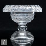 A late Georgian Anglo-Irish clear crystal table centre with a deep roll rim above a large hollow