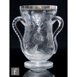 An early 20th Century Stevens and Williams glass loving cup of footed waisted form with polished