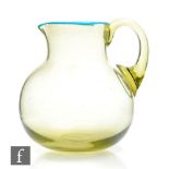 A Victorian Sowerby Venetian glass jug, of compressed ovoid form with collar neck and applied loop