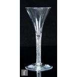 An 18th Century drinking glass, circa 1760, the trumpet bowl above an incised stem, raised to a