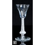 An 18th Century drinking glass, circa 1755, the pan topped bowl above a multiple series air twist