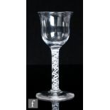 An 18th Century drinking glass, circa 1765, the waisted ogee bowl above a double series opaque twist