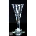 An 18th Century drinking glass circa 1740, the drawn trumpet bowl above a plain stem with internal
