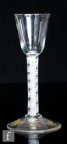 An 18th Century drinking glass, possibly a gin glass, circa 1765, the round funnel bowl over a