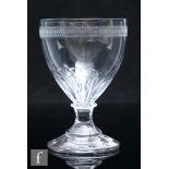 An early 19th Century glass rummer, circa 1800, with petal moulded ogee bowl with engraved border,