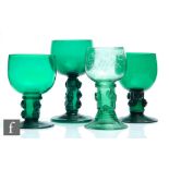 A group of four 19th Century Bristol green drinking glasses to comprise four variant Roemer type