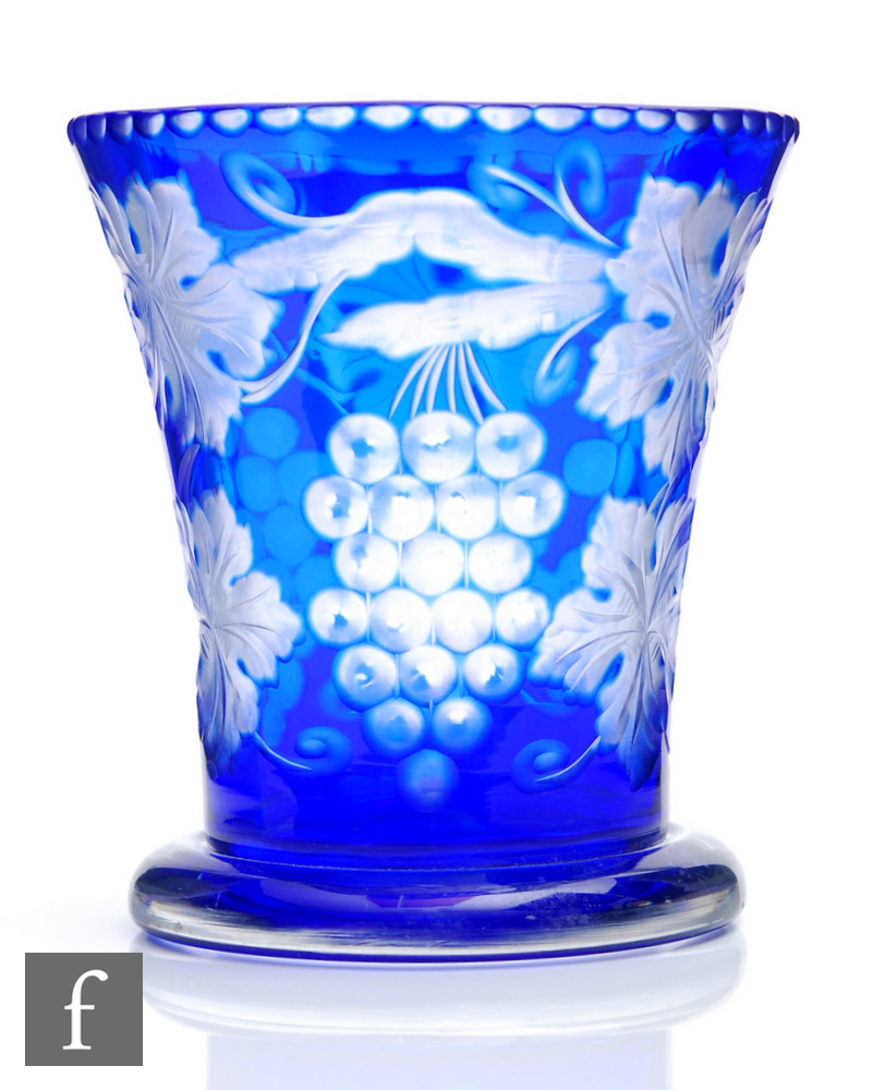 A 1930s Stevens & Williams glass vase of footed flared form cased in blue over clear crystal and cut