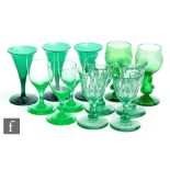 A collection of 19th Century green drinking glasses to include trumpet, round funnel, slice cut bell