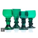 A group of four 19th Century Bristol green drinking glasses to comprise four variant Roemer type