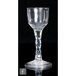 An 18th Century drinking glass circa 1785, the round funnel bowl with basal facet cuts above a