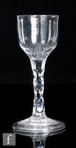 An 18th Century drinking glass circa 1785, the round funnel bowl with basal facet cuts above a