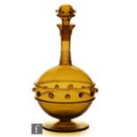An early 20th Century, possibly German, decanter raised on a circular spread foot, of globe and
