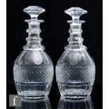 A pair of late 19th Century clear crystal glass decanters of Prussian shape with basal and