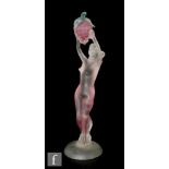 A later 20th Century Italian figure of a standing female nude holding a bunch of grapes aloft,