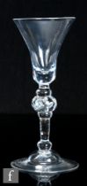 An 18th Century composite drinking glass circa 1750, the slender pointed round funnel bowl with
