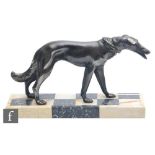 An Art Deco spelter study of a standing borzoi, all to a black and cream checkerboard marble base,