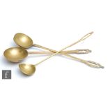 Three assorted 19th Century and later brass ladles, each with circular bowls and hanging loops to