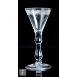 An 18th Century drinking glass, circa 1730, the trumpet bowl engraved to the upper border with a