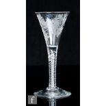 An 18th Century drinking glass, circa 1765, the trumpet bowl engraved with a bird in flight and a